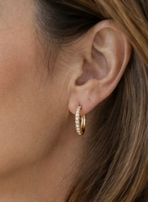 Model wearing Maylohas Classic CZ Huggie Hoop Earrings